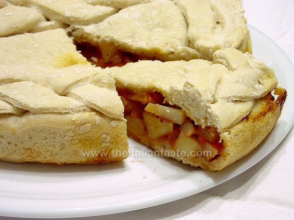 Double pizza filled with potatoes and tomatoes